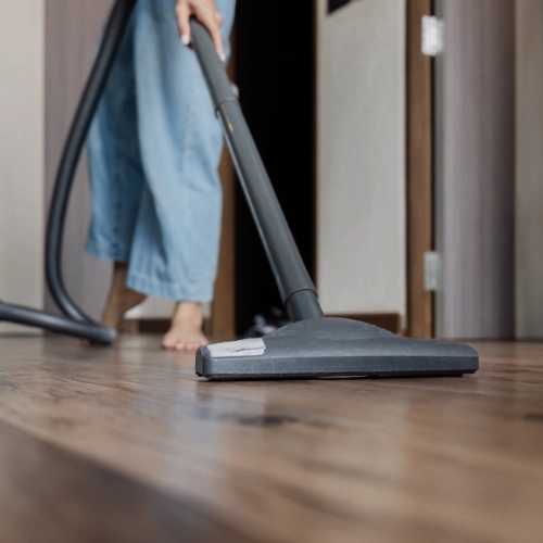 A woman using a vacuum