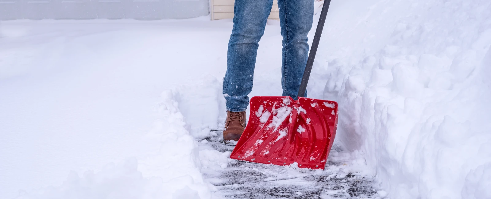 Man shoveling snow in drive