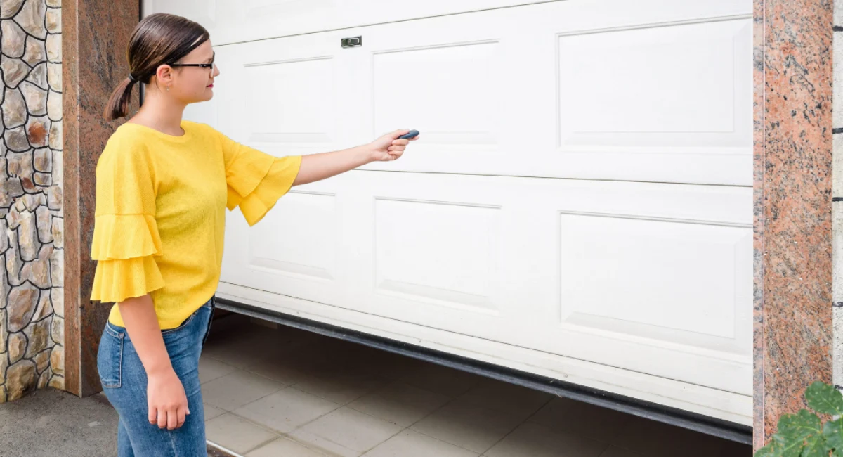 Woman locking her garage door with remote