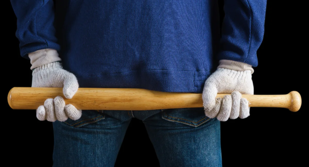 Man holding bat with gloves
